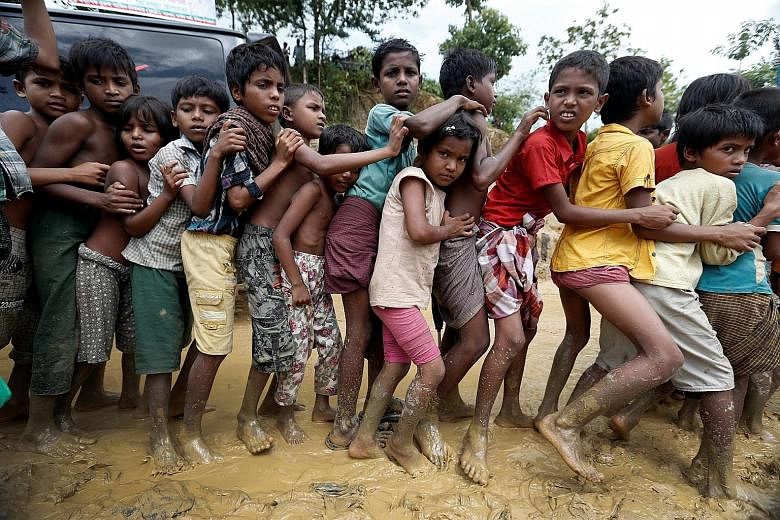 Rohingya refugee children queueing for aid in Cox's Bazar, Bangladesh, on Thursday. Doctors Without Borders has warned that the country's refugee camps are on the brink of a "public health disaster".