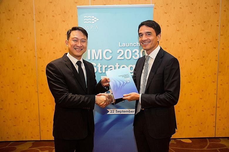 Senior Minister of State for Transport Lam Pin Min receiving a copy of the International Maritime Centre 2030 Advisory Committee's report from committee chairman Andreas Sohmen-Pao at Marina Bay Sands.