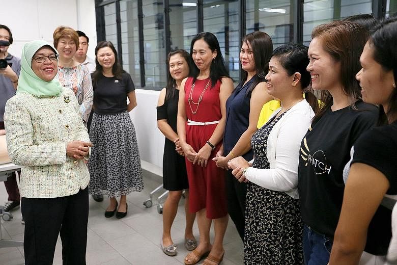 President Halimah Yacob chatting with a group of foreign domestic workers at Agape Village yesterday. She also dropped in at the Mamre Oaks day activity centre for adults with intellectual disabilities.
