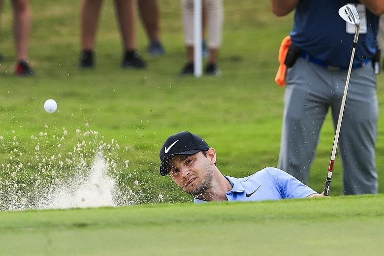 American Kyle Stanley hits from a sand trap by the 18th green during the first round of the Tour Championship in Atlanta, Georgia, on Thursday. He leads by two shots with six-under 64.