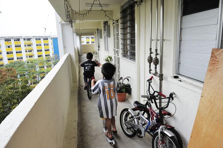 Children playing along the corridor of two-room HDB flats in Boon Lay Drive. One key change that unmarried parents are seeking is to allow them equal access to HDB flats as married couples, instead of making them wait till they are aged 35 and limiti