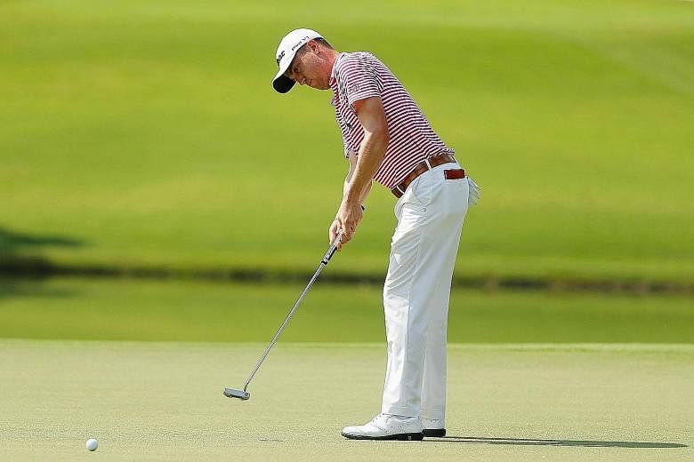 Justin Thomas putting on the eighth green in the second round of the Tour Championship. He eagled the final hole with a superb approach shot to share the halfway lead with Webb Simpson and Paul Casey.