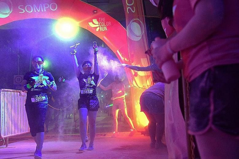 About 9,000 participants ran a 5km loop around Palawan Green in Sentosa as glow-in-the-dark powder bathed them in iridescent, neon particles. The Colour Run, in its fifth edition here, took on a different tinge this year by taking place at night - th