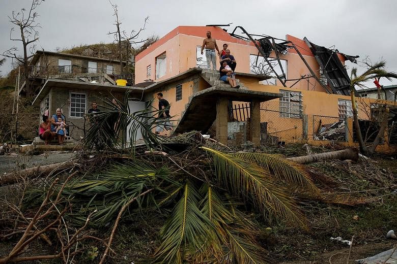 A damaged house in Yabucoa, Puerto Rico, in the aftermath of Hurricane Maria, which has killed at least 25 people across the Caribbean, according to officials and media reports.
