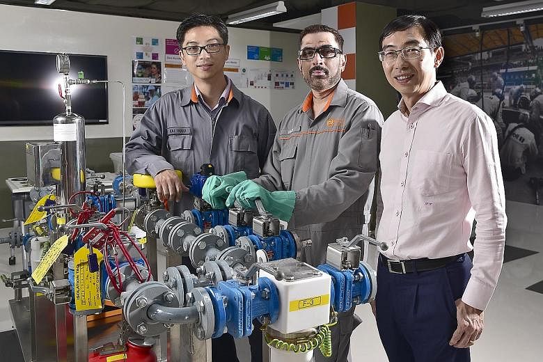 (From left) GlaxoSmithKline staff members, Mr Chong Kai Hau, 41, production manager; Mr Selvaraju Murugayen, 54, senior operations technician; and Mr Lim Hock Heng, vice-president and site director in a site learning zone at GSK, where employees can 