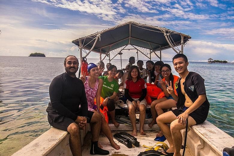 Ms Chong Lee Ling (in red) leading a snorkelling trip to Indonesia's Togean Islands in August last year. 3Playgrounds' adventure tours are filled with sports and outdoor activities, such as rafting, cycling, trekking and horse-riding, and 70 per cent