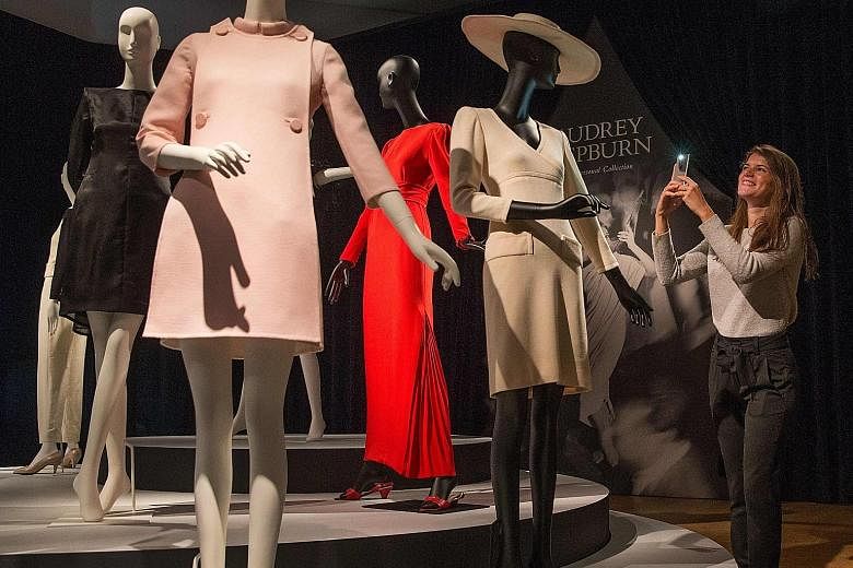 Audrey Hepburn's outfits (above), ballet pumps, script for the 1961 film Breakfast At Tiffany's and monogrammed powder compact at an exhibition at Christie's auction house in London.