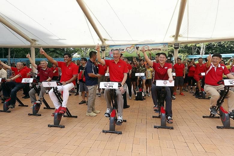 Prime Minister Lee Hsien Loong with fellow Ang Mo Kio GRC MPs (from far left) Ang Hin Kee and Darryl David, as well as Sengkang West MP Lam Pin Min, riding their hearts out yesterday as part of a special challenge to mark Ci Yuan Day. Every kilometre