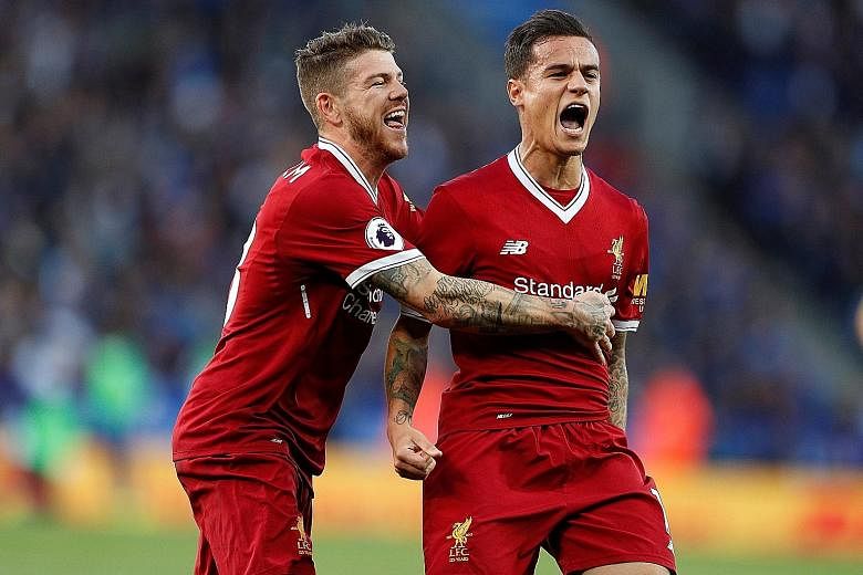 Above: Liverpool's Philippe Coutinho (right) celebrating with Alberto Moreno after scoring their second goal against Leicester City on Saturday. The Brazilian's performance was crucial in securing victory and moving Jurgen Klopp's side up to fifth in