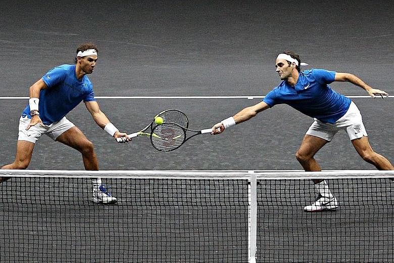 Rafael Nadal and Roger Federer (right) in action on the same side of the net for once. The duo combined for Team Europe to beat Team World pair Sam Querrey and Jack Sock in their Laver Cup doubles match on Saturday.