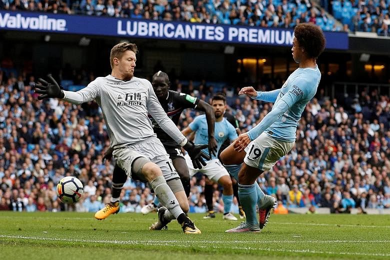 Leroy Sane puts the ball through Palace goalkeeper Wayne Hennessey's legs to net the first goal. His strike opened the floodgates for Manchester City to eventually win 5-0 after a goal-less first half.