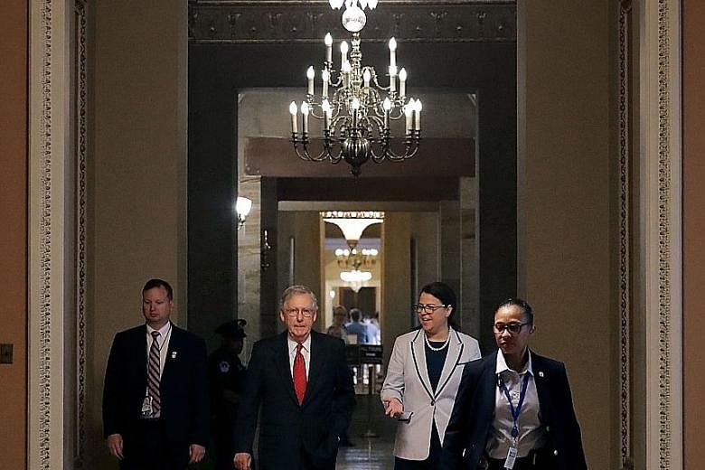 Senate Majority Leader Mitch McConnell (second from left) and the rest of the so-called "Big Six" negotiators, are expected to seek a top individual tax rate of 35 per cent, down from the current 39.6 per cent.