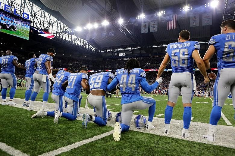 Detroit Lions players kneeling during the US national anthem on Sunday.