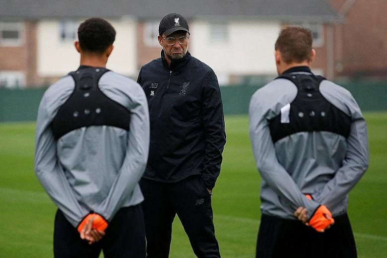 Liverpool manager Jurgen Klopp working on his side's tactical discipline during training ahead of today's Champions League clash at Spartak Moscow. They may lack defensive nous, but scoring goals is not an issue, with Klopp set to field his first-cho