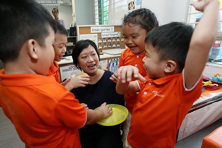 Ms Karina Anne Lee, 38, with some children from My First Skool in Toa Payoh yesterday. The assistant teacher says she was inspired by the "energy and passion" of the pre-school teachers who nurtured her three children.