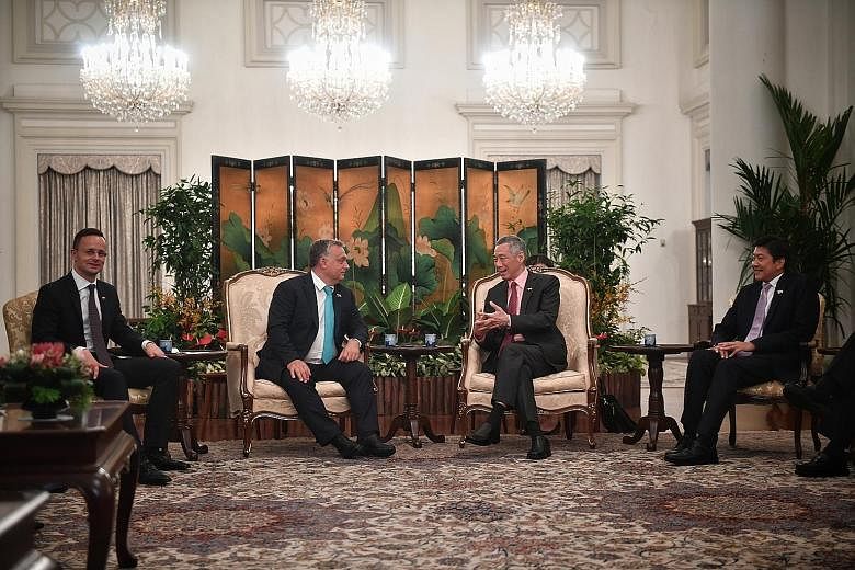 Prime Minister Lee Hsien Loong speaking with Hungarian Prime Minister Viktor Orban at the Istana yesterday. Flanking them are Hungarian Minister for Foreign Affairs and Trade Peter Szijjarto and Singapore's Minister for Education (Schools) and Second