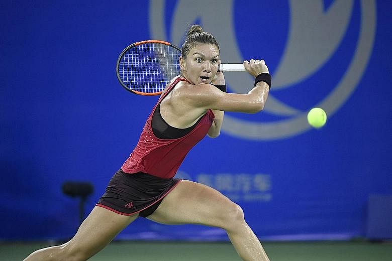 Romanian Simona Halep in action against Russian Daria Kasatkina during their second-round match. She joined the growing list of big-name Wuhan Open upsets.