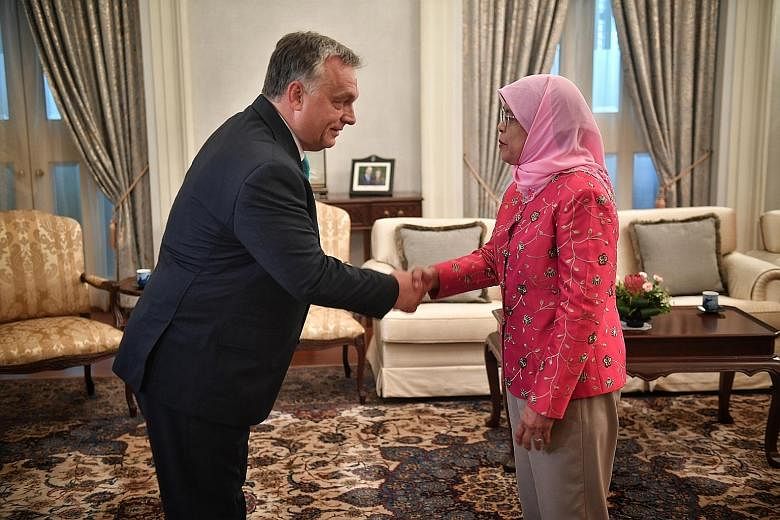 Hungarian Prime Minister Viktor Orban meeting President Halimah Yacob at the Istana yesterday. Mr Orban, who is here on a two-day official visit, was the first foreign leader to call on Madam Halimah since she was sworn in as President on Sept 14. Th