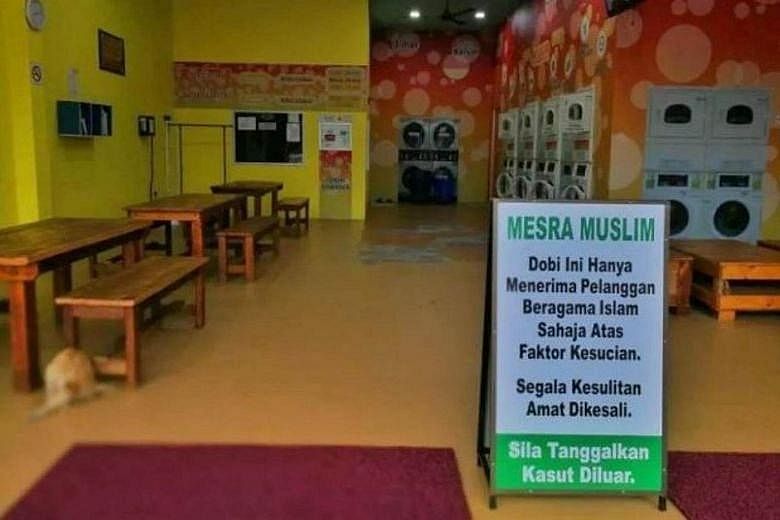 A sign at the entrance of the laundry saying it only accepts clothes from Muslim customers for "reasons of cleanliness".