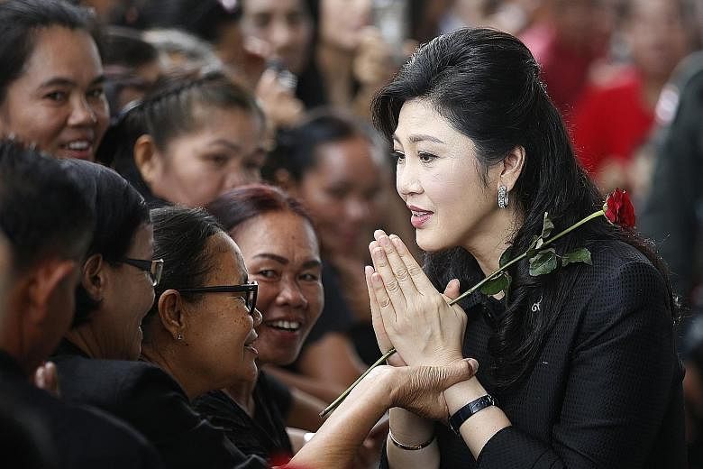 Former Thai prime minister Yingluck Shinawatra greeting supporters as she arrived for her trial in June. She fled abroad last month, fearing that the military government would seek a harsh sentence.