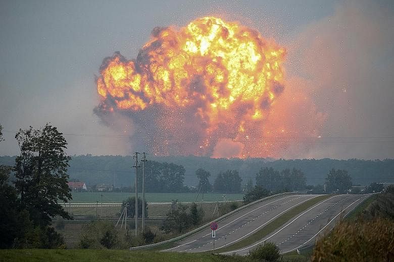 Smoke and flames rising over a weapons storage site, which contained some 83,000 tonnes of munitions, in the Vinnytsia region in Ukraine. A fire broke out at the depot on Tuesday night, causing artillery shells at the facility to explode one after an