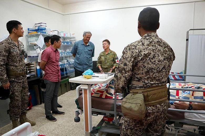 Defence Minister Ng Eng Hen, with (from left) Chief of Defence Force Perry Lim and Senior Minister of State for Defence Maliki Osman, visiting the Singapore Armed Forces medical team at the coalition camp in Iraq on Tuesday.