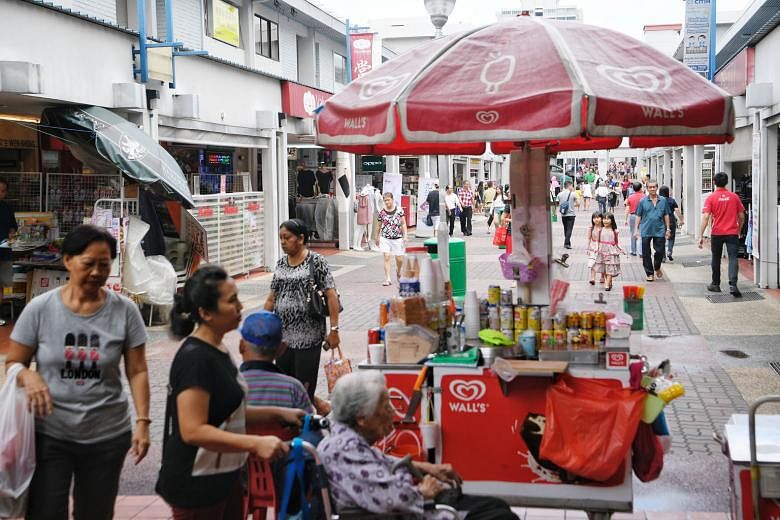 Older towns such as Ang Mo Kio have hawker centres and street-level shops (above) where residents can mingle, features lacking in newer estates with their mall-based neighbourhood centres like Punggol's Waterway Point.