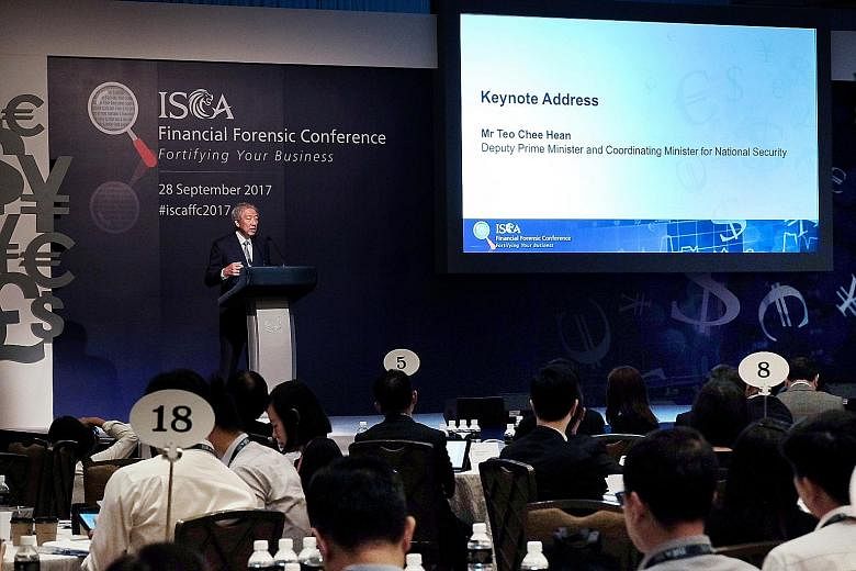 Deputy Prime Minister Teo Chee Hean delivering his keynote address at the Institute of Singapore Chartered Accountants Financial Forensic Conference yesterday. He said the authorities will work with the private sector to target individuals involved i