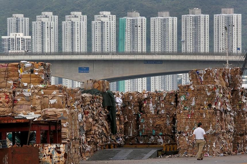 Stacks of paper waste at a dock in Hong Kong, after China imposed a ban on imports of 24 types of rubbish, including unsorted scrap paper, in July.