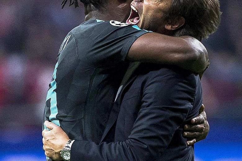 Substitute Michy Batshuayi embracing Antonio Conte after his goal sealed a 2-1 victory against Atletico Madrid on Wednesday. The Blues are now unbeaten in Group C of the Champions League.
