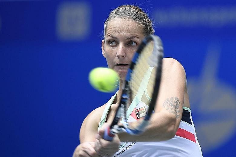 Czech Karolina Pliskova (top) returning against Australia's Ashleigh Barty (above) during their women's singles quarter-final match at the WTA Wuhan Open. The world No. 4 failed to usurp top-ranked Garbine Muguruza of Spain as a result of her loss.