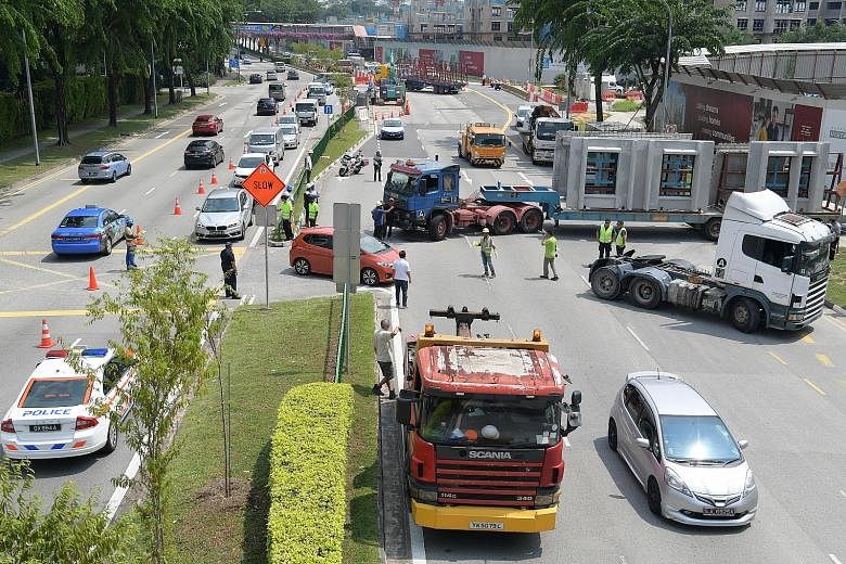 The trailer was sprawled across all four lanes in the direction of Serangoon Road, cutting off traffic completely during the morning rush hour. A road diversion was created using one lane on the opposite side of the road to let vehicles pass. The tra