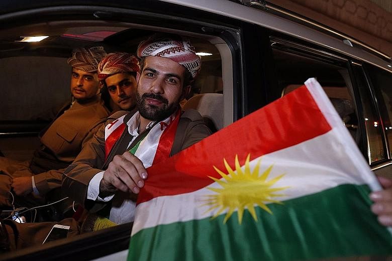 Kurds celebrating after the announcement of the independence referendum results, which show 92.73 per cent of voters backed statehood.
