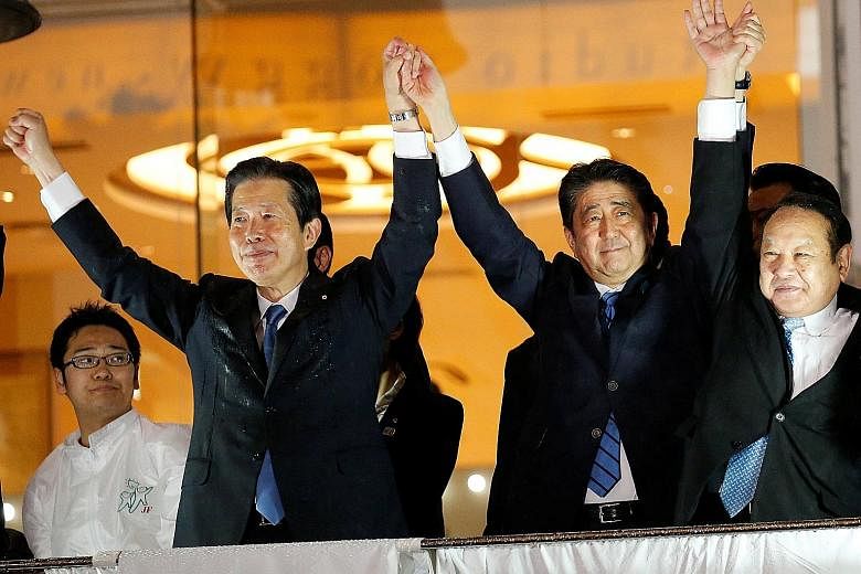 Japanese Prime Minister Shinzo Abe (right) with coalition partner Komeito party's leader Natsuo Yamaguchi in Shibuya, Tokyo, on Thursday.