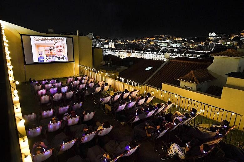 Leisure with views: Lisbon's Torel public pool (above) and a movie screening (below) on the terrace of the Topo Chiado bar and restaurant.