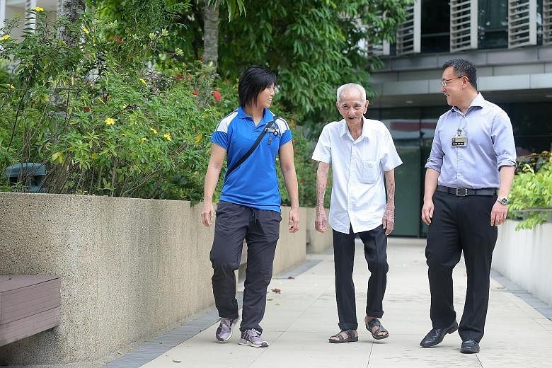 Mr Tan Cheng Hong, 90, benefited from the transdisciplinary care at KTPH when he underwent surgery in May. Monitoring his progress are senior physiotherapist Kylie Siu and Dr Tan Kok Yang, head of surgery.