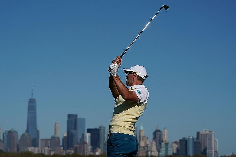From top: Adam Scott tees off on the 10th hole at the Liberty National Golf Course, which offers views of the Manhattan skyline. US team golfer Jordan Spieth talking with assistant captain Tiger Woods (far left) during the Presidents Cup. Spieth, 24,