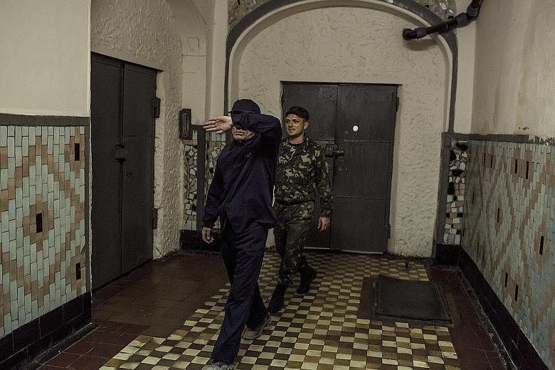 Convicted North Korean spy Ri Tae Gil (left) in the No. 8 Prison in Zhytomyr, Ukraine, in 2011. Deputy warden Anatoly Gabitov describes Ri as a "super inmate" who never causes trouble.