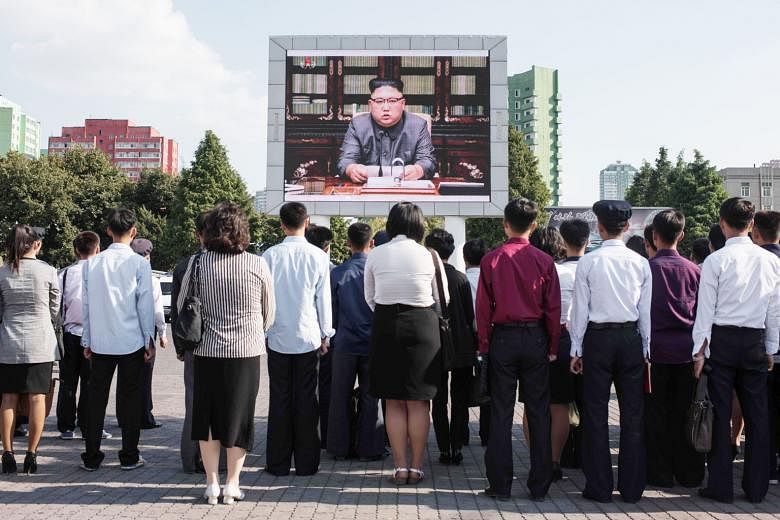 North Koreans watching a TV broadcast of their leader Kim Jong Un giving a statement on Sept 22 in which he blasted US President Donald Trump as being "mentally deranged". He also warned that Mr Trump will "pay dearly" for his threat to destroy North