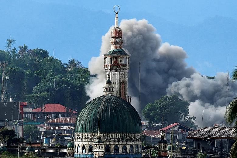 The conflict in Marawi (left) began in May. Despite losing ground to the Philippine armed forces, militants there have defied predictions and proven difficult to root out.
