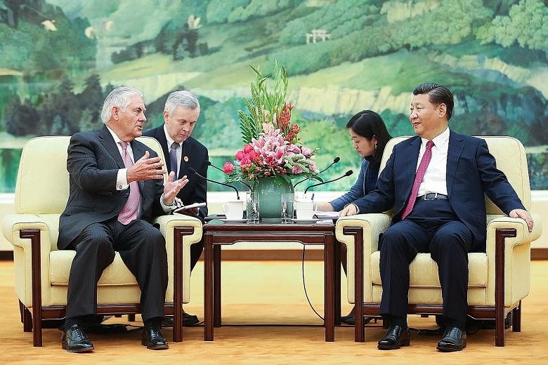 US Secretary of State Rex Tillerson with Chinese President Xi Jinping at the Great Hall of the People in Beijing yesterday. Mr Tillerson met with senior Chinese officials to lay the groundwork for Mr Donald Trump's trip.