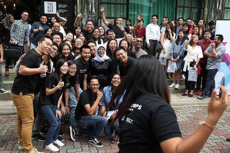 President Halimah Yacob posing for a wefie with Youth Corps Singapore members yesterday at The Red Box. They were part of 60 young people the President had a dialogue with at an event organised by the National Youth Council. President Halimah urged c