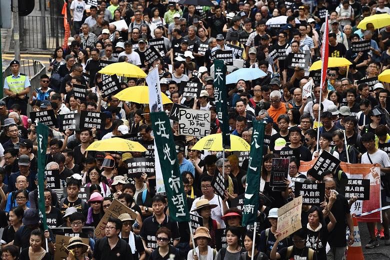 Demonstrators in Hong Kong taking to the streets for a pro-democracy rally yesterday, which was also China's national day.