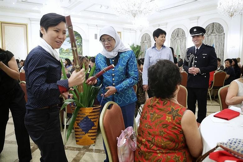Sugar cane, pandan leaves and a banana cake. These were some of the items Ms Manda Foo (holding sugar cane) and Mrs Ivy Singh-Lim of the Gentle Warriors' Trust gave President Halimah Yacob yesterday at the Istana, where the President hosted a lunch f