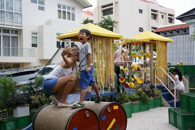 Alisteir Teo, five, and his mother Iori Chua, 39, at the playground, which comprises structures made of tyres, drink crates and barrels.