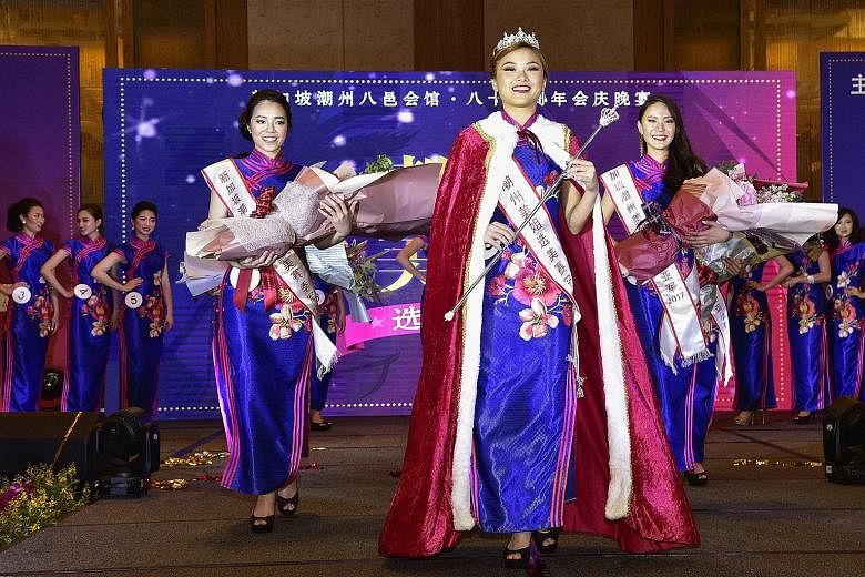 Newly crowned Miss Teochew pageant winner Angele Chan, a student, is flanked by first runner-up Jaslyn Tan (far right), a property agent, and second runner-up Pow Chen Wei, a research coordinator, at the finals on Saturday. Pageant finalists (front, 