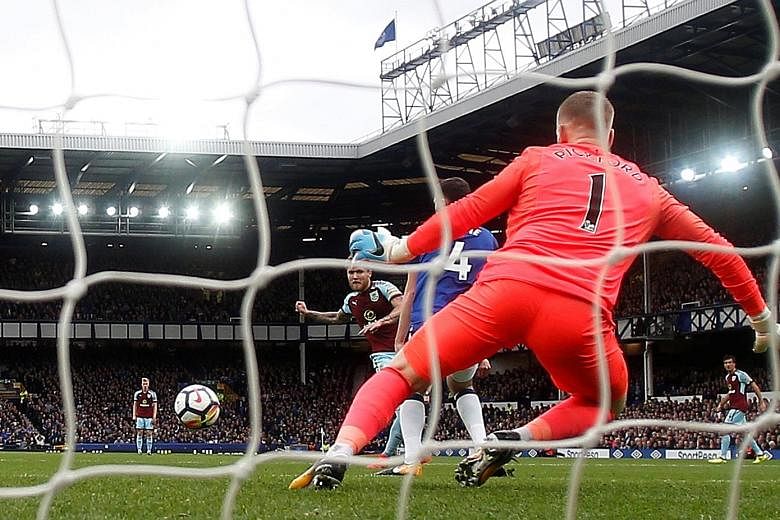 Burnley midfielder Jeff Hendrick capping off a 24-pass move by beating Everton goalkeeper Jordan Pickford in a Premier League match at Goodison Park yesterday.