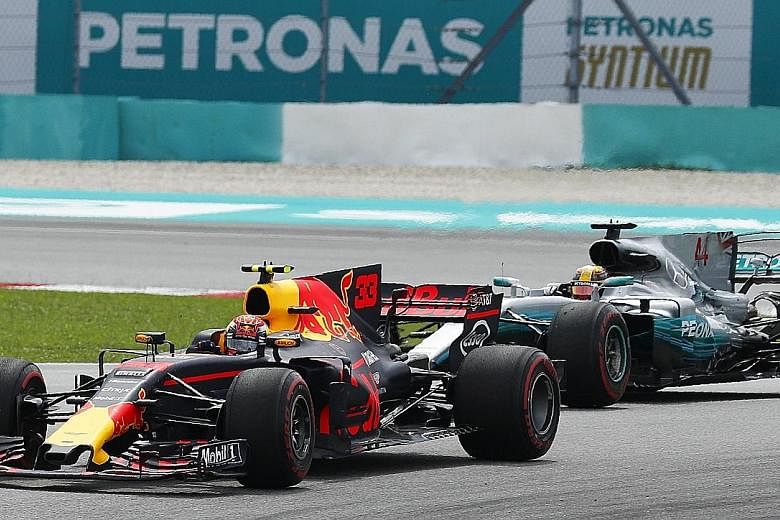 Red Bull driver Max Verstappen gliding up the inside at turn one to overtake Mercedes' pole-sitter Lewis Hamilton on lap four of yesterday's Malaysian Grand Prix.