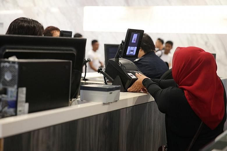 Thumbprint-scanning at the Singapore Cruise Centre. Car drivers and passengers passing through the Tuas and Woodlands checkpoints must now also have their thumbprints scanned for security reasons.
