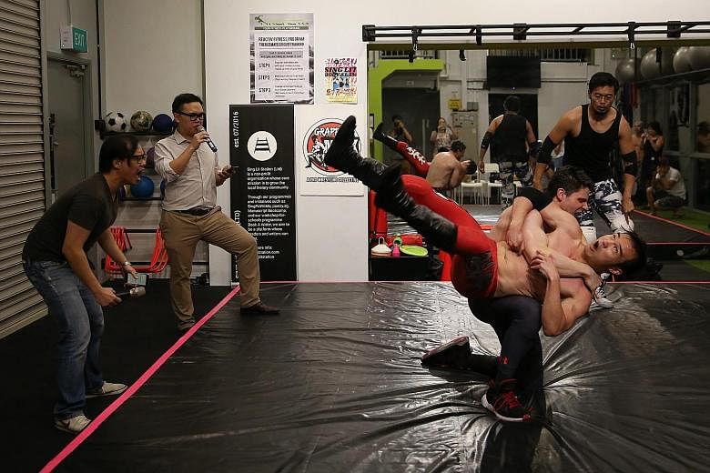 Poets (from far left) Joses Ho and Joshua Ip war verbally while wrestlers Greg Ho (in red tights) and Jeff Ederer fight in choreographed synchrony.